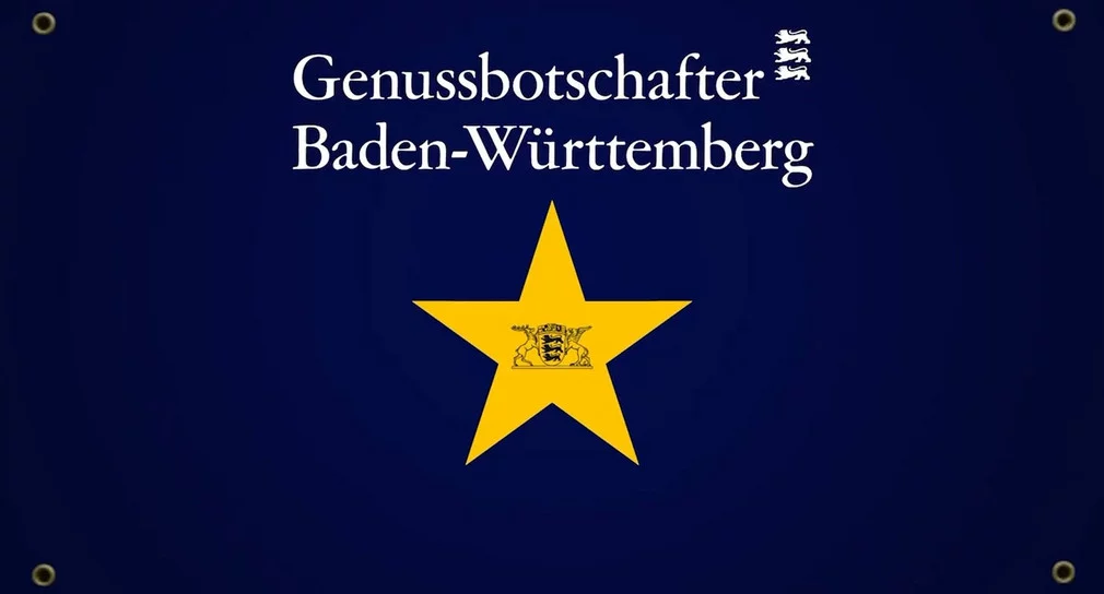 Ein gelber Stern auf einem dunkelblauen Hintergrund mit der weißen Überschrift Genussbotschafter Baden-Württemberg.